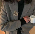Broche Acero Logo